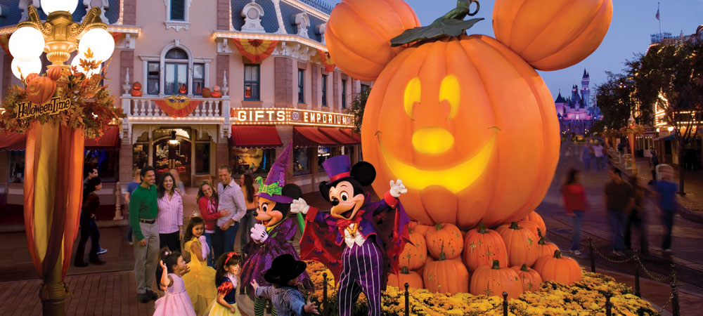 Mickey and Minnie Greet Guests In Front of a Giant Mickey Pumpkin