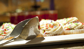 An alluring plate of cupcakes with rainbow sprinkles.