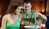 A couple shares an appetizer at the bar.