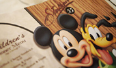 Mickey Mouse and Pluto appear on the children's menu.