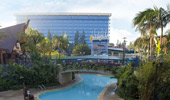 A wide shot of the Disneyland Hotel, one of the 3 pools and the footbridge.