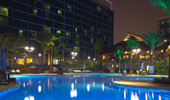 An evening shot of the E-Ticket Pool and 2 of the Disneyland Hotel Towers.