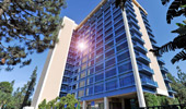 Looking up the Frontier Tower at the Disneyland Hotel, the sun glints off the blue-tinged glass.
