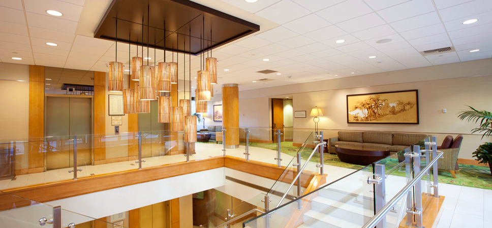 An elegant yellow glass chandelier hangs over the lobby's open stairwell.