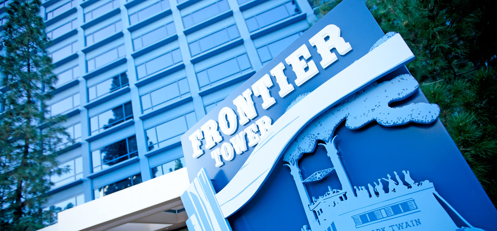 The Frontier Tower sign with an illustration of the Mark Twain Riverboat attraction.