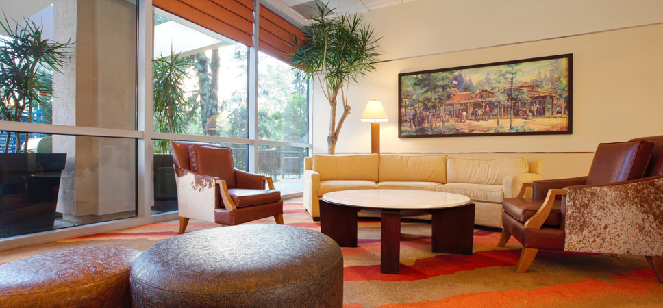 The lobby's waiting area is decorated with wood, leather and warm earth tones.