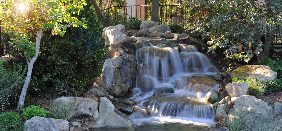 A small falls fills a landscaped area near the Frontier Tower.