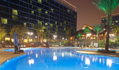 An evening shot of the E-Ticket Pool and 2 of the Disneyland Hotel Towers.
