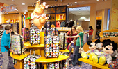 Guests look at Disney merchandise on the Fantasia Shop shelves.