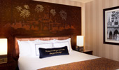 Disney fairy tale touches, like wood headboard, stitched pillow and framed photos, are found in each room.