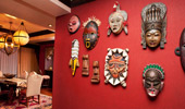 Masks decorate an intensely red wall.