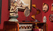 Decorative Suite pieces, like mounted butterflies and carved masks.