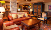 Living area with warm wood and leather furniture.