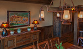 Wood paneling and a chandelier made from miner's lamps.