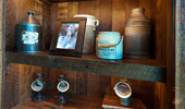 Preserves jar, sugar syrup tin, jugs and framed photos.