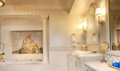 Wide shot of the white and gold bath, and mosaic feature.