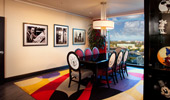 Framed images of Mickey Mouse and Walt Disney on the wall, sculptures of Mickey in a display case.