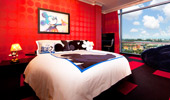The Suite's second bedroom is brightly decorated in red and yellow.