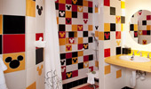 The additional bathroom is done in the colors that define Mickey Mouse.