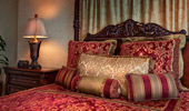 Vintage, 4-poster bed with plush pillows and canopy cover.