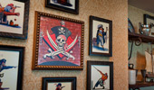 Close up of framed pictures and items on a display shelf.