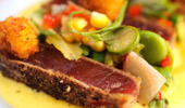 Close up of seared and crusted ahi tuna steak and sides.