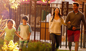 A family of 4 enjoys a walk in the sunshine and gorgeous gardens.