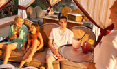 A family of 4 enjoys poolside service inside the rented cabana