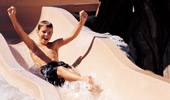 A boy has fun on a water slide at Disney's Grand Californian Hotel & Spa pool.