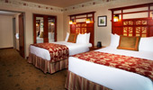Wide shot of standard room with queen-size beds and surroundings