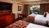 From the queen-size beds see the TV, dresser and exit to balcony.