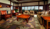 Couches and chairs surround an elegant carpet in the living area of the Mount Whitney Signature Suite. 