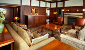 Plush couches and arm chairs in the living area of the Suite