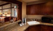 The wet bar provides a coffee maker, a microwave and plenty of cabinet space stocked with cups and plates.