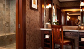 Near the shower stall, a make-up station provides multiple mirrors, plush towels and ample lighting.