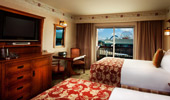 From the 2 queen-size beds see the TV, dresser and exit to balcony with partial theme park view
