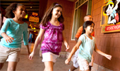 4 young Guests are excited to enter Pinocchio's Workshop.