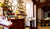 Wide shot of entry room of Mandara Spa with shelves of oils, lotions, polish and products.