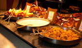 Signs next to hot dishes: Chicken Flautas, Oatmeal with Golden Raisins, Chicken Breast Nuggets.
