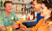 A couple purchases 2 refreshing drinks at the poolside snack and drink shop.