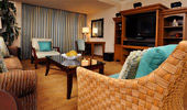The beach themed continues in the living area with rattan furniture and bright patterns.