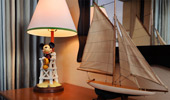 A delightful desk lamp has a base with Mickey Mouse on a life guard's chair.
