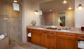 2 vanities, a large mirror, a shower stall, a bath tub and plenty of cabinet space.