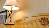 A delightful desk lamp has a base with Mickey Mouse on a life guard's chair.