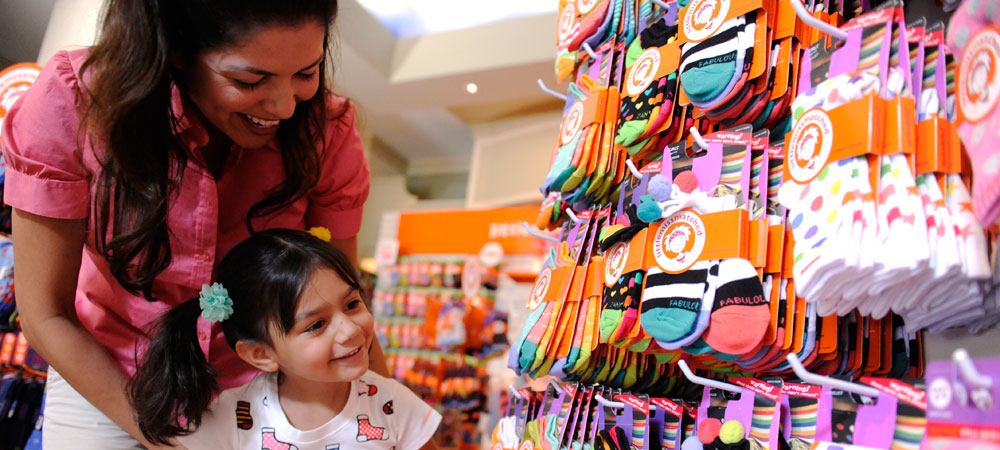 A Mother and Daughter Looking at a Display of Colorful Socks as They Shop