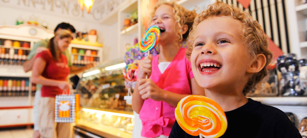 Delighted Kids with Lollipops at Marceline's Confectionery